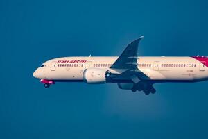 New Delhi, India, December 25 2023 - Air India Airbus A320 take off from Indra Gandhi International Airport Delhi, Air India domestic aeroplane flying in the blue sky during day time photo