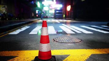 A red and white traffic cone sitting on the side of a road video