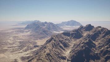 A group of mountains in the middle of a desert video