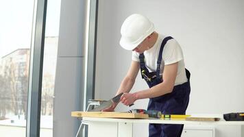The carpenter sawing the parts video