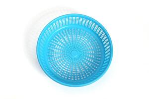 Empty Blue Plastic Basket with soft shadow on white background. Top view. photo