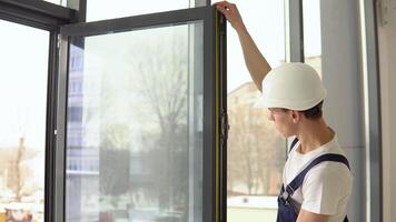 The window installer measures the dimensions of the window frame with a meter tape video