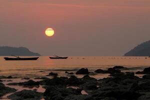 Silhouette of fishing boat on a sea. photo