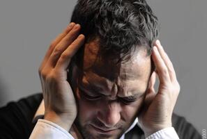 AI generated A man grips his head to ease a headache, labour day background photo