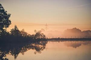 Misty morning at pond photo