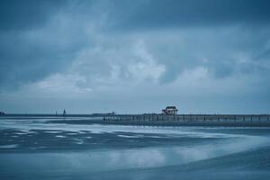 beach of sankt peter-ording germany on overcast day photo