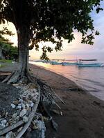 Fishing boats anchor on the beach in the afternoon, when the sunsets photo