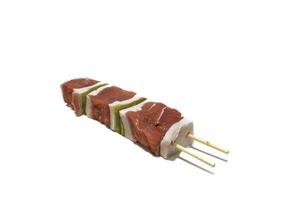 Raw meat and pepper skewers, isolated on a white background. Generally a skewer is made up of pieces of meat or fish interspersed with onion, pepper, mushrooms, etc. photo