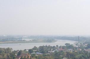 View of Village and River in Rural Area of Thailand on Misty Day Because of PM2.5 Air Pollution photo