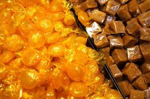 Butterscotch Discs and Caramels Wrapped in Cellophane photo