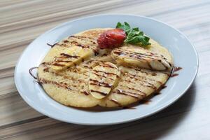 Banana Pancake served in White plate photo