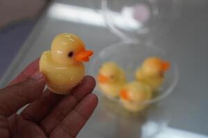 Duck shaped jelly sweet food in hand photo