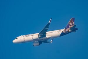 New Delhi, India, December 25 2023 - Vistara Airbus A320 neo take off from Indra Gandhi International Airport Delhi, Vistara domestic aeroplane flying in the blue sky during day time photo