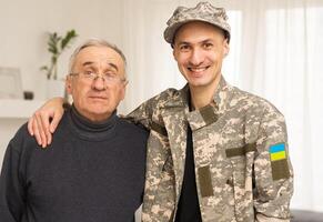 Soldier in military uniform reunited with his family and Ukrainian flag photo