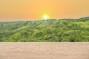 Wood table top on blurred background of sun set - can used for display or montage your products. photo