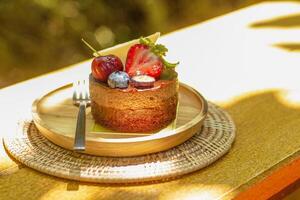 Chocolate Hazelnut Cake decorated with strawberry, raspberry, Blueberry,  and chocolate sauce. photo