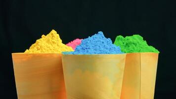 Color Powder Cups On Black For Holi Festival photo