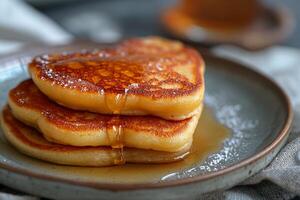 AI generated stack of heart-shaped pancakes with honey on a plate. View from above. Served on the kitchen table for breakfast photo