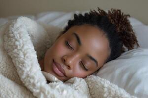 AI generated Woman peacefully sleeping in bed, enveloped by a luxurious white fluffy blanket, showcasing a contemporary DIY aesthetic with African influence photo