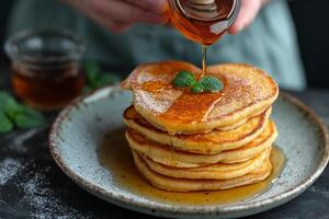 AI generated stack of heart-shaped pancakes with honey on a plate. View from above. Served on the kitchen table for breakfast photo