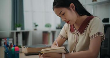 Side view, Female writer sitting at desk while thinking idea holding pen making notes in diary at home, creative thoughts to journaling, idea and inspiration photo