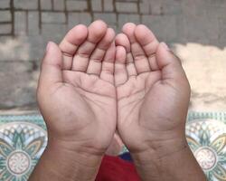 a small child's hands praying for blessings from god photo