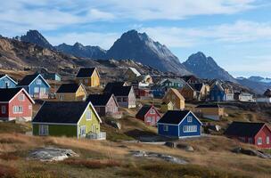 AI generated Colorful village against mountain backdrop in Greenland photo