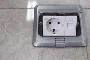 Pop up floor socket for Outlet data socket on tile floor. Floor outlet plug adapter. photo