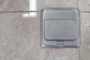 Pop up floor socket for Outlet data socket on tile floor. Floor outlet plug adapter. photo
