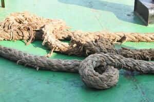 a very large ship's rope is used to tie up ships when they dock at the port photo