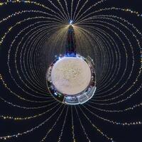 new year tiny planet with Christmas tree. Spherical aerial 360 panorama night view on festive square with illumination in form of tent photo