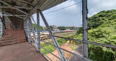 full loop 360 rotation inside iron steel frame construction of pedestrian crossing over railway video