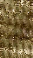 vertical video of rows of blinking golden yellow brass metal plaques sway in wind and shines in sun and create unique pattern of movement. round reflective particles glitter under waves of wind