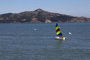Sausalito, CA, 2011 - Small sailboat on bay two young boys photo