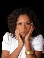 Pretty young black woman with hands along face photo