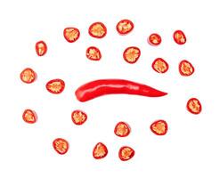 Top view of single fresh red chili pepper with slices or pieces isolated on white background with clipping path photo