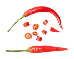 Top view and flat lay of curved fresh red chili peppers with slices in set isolated on white background with clipping path photo