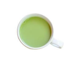 Top view of hot matcha latte green tea in small white cup isolated on white background with clipping path photo