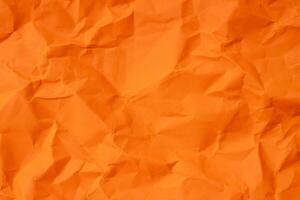 Top view of orange wrinkled or crumpled paper texture used as crumpled paper background texture in decorative art work photo