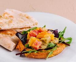 Healthy roasted red pepper hummus and pita bread photo