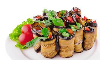 Rolls of fried eggplant stuffed with mayonnaise and tomatoes photo