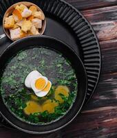 Homemade bouillon or broth with egg photo