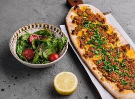 Pide is a Turkish flatbread stuffed with minced lamb and beef photo