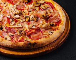 pizza with ham, salami and mushrooms photo
