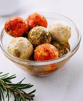 Small balls of goat cheese rolled in different spices photo