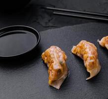 Gyoza or dumplings snack with soy sauce photo