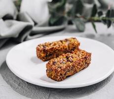 Two granola bar on white plate photo