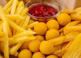 Different types of fried potatoes, such as french fries, roast potatoes and potato balls photo