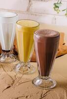 milkshake glasses featuring different flavors photo
