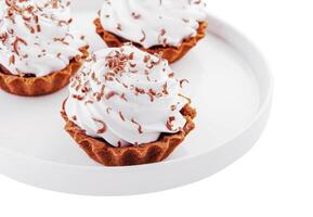 Small chocolate tarts with whipped cream photo
